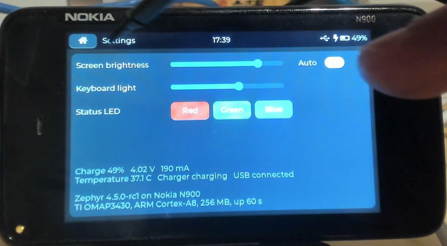 Settings with brightness and keyboard light sliders and battery details
