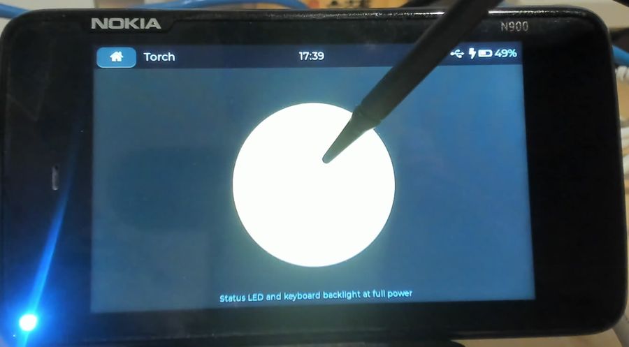 Torch app switched on, status LED glowing at the corner